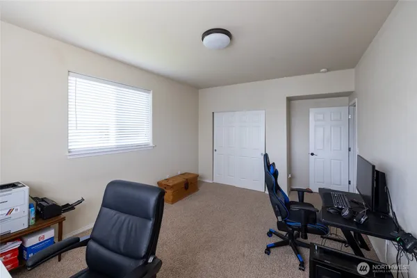 a bedroom with a bed and a painting on the wall
