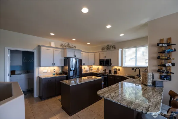 a kitchen with granite countertop sink cabinets and refrigerator