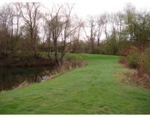 667 Cronin Road Warren, MA 01585 - Photo 10 of 15 a view of a lake with a yard