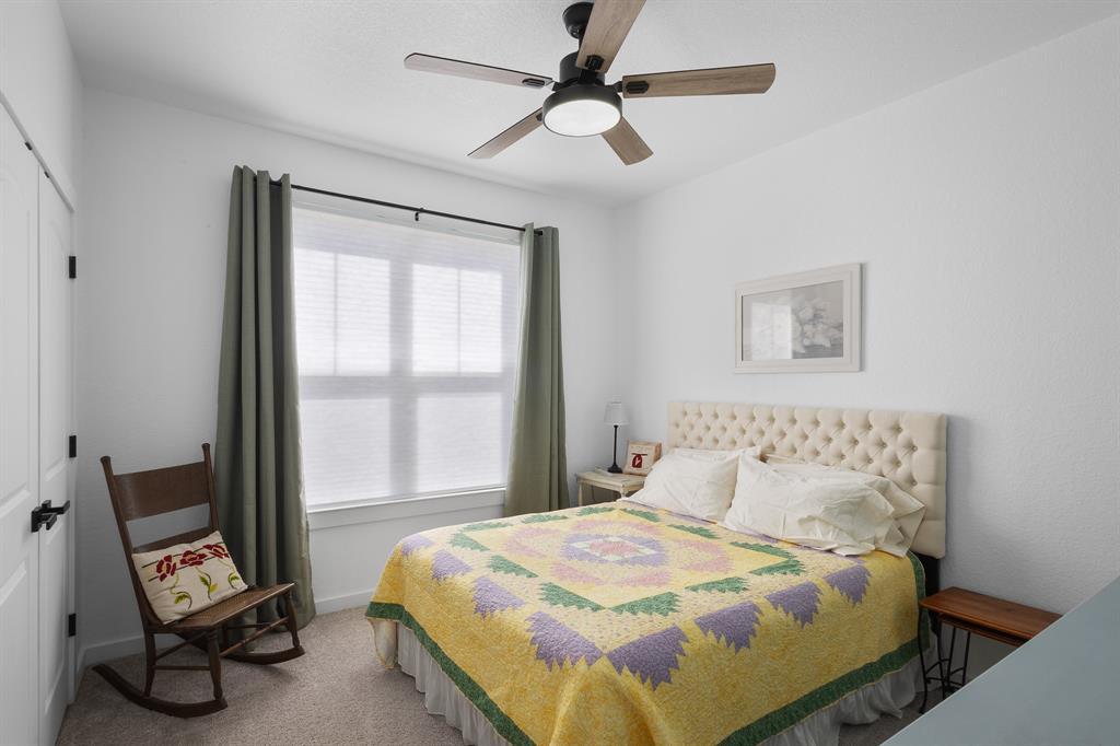 116 Lindsey Lane Runaway Bay, TX 76426 - Photo 20 of 35 a bedroom with a bed a couch and a window