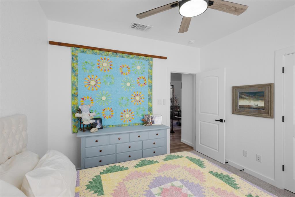 116 Lindsey Lane Runaway Bay, TX 76426 - Photo 21 of 35 a bedroom with a bed and a dresser