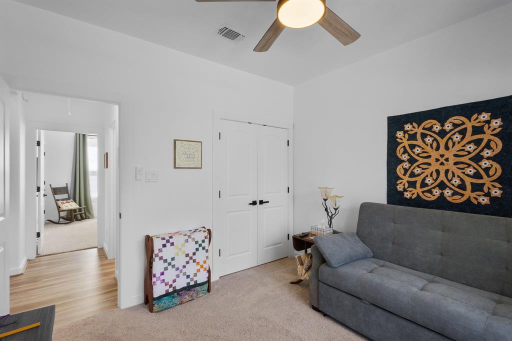 116 Lindsey Lane Runaway Bay, TX 76426 - Photo 23 of 35 a living room with furniture and a chandelier
