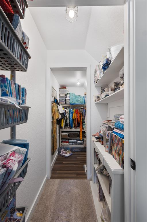 116 Lindsey Lane Runaway Bay, TX 76426 - Photo 32 of 35 a hallway with a white stove top oven a rug and a bookshelf