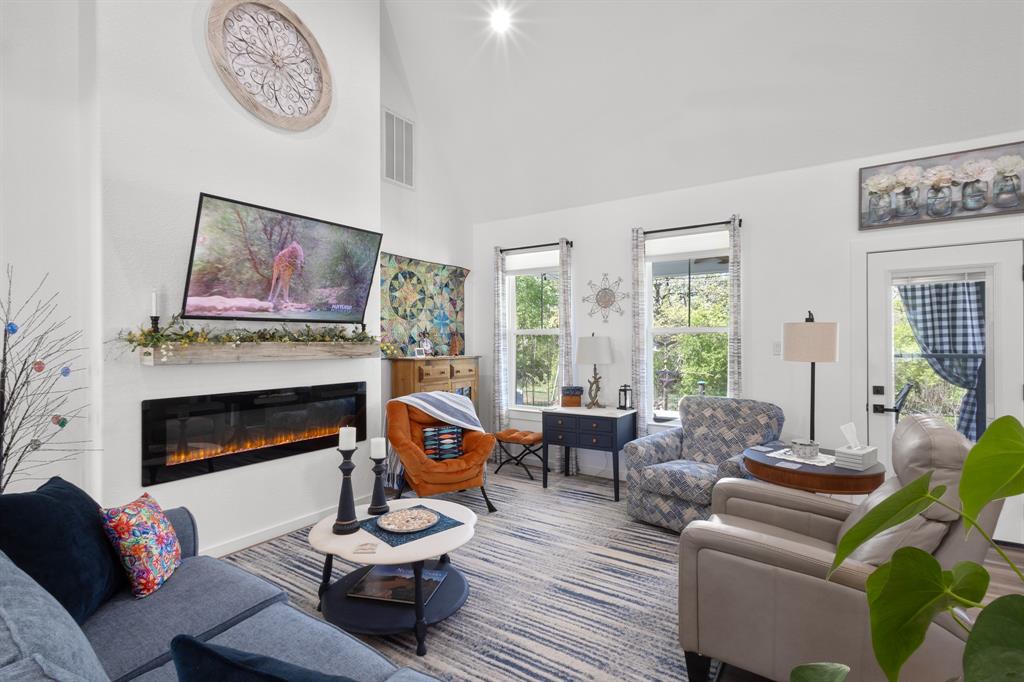 116 Lindsey Lane Runaway Bay, TX 76426 - Photo 10 of 35 a living room with furniture a fireplace and a large window