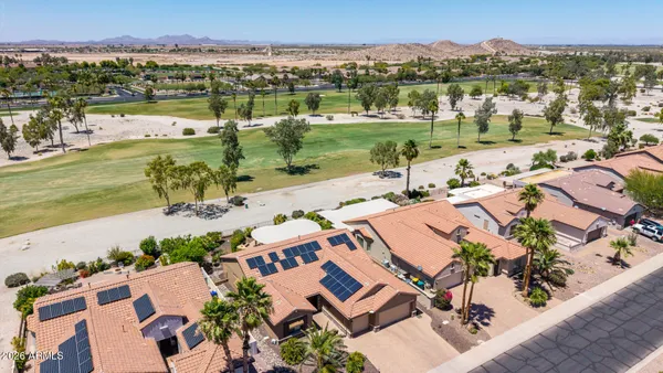 an aerial view of multiple houses with yard