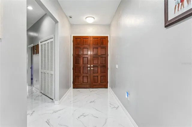 a living room with a fireplace and a floor to ceiling window
