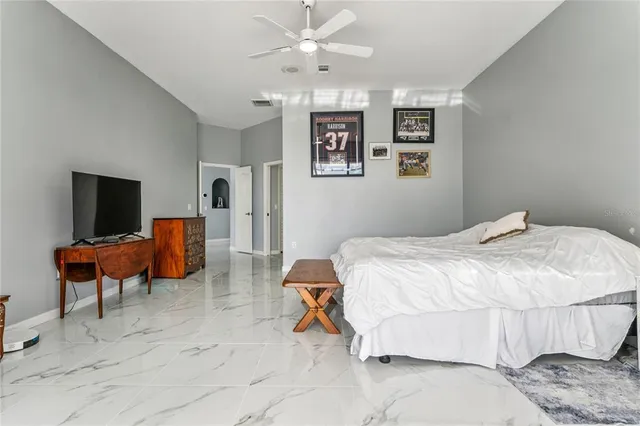 a bedroom with a bed and a large window