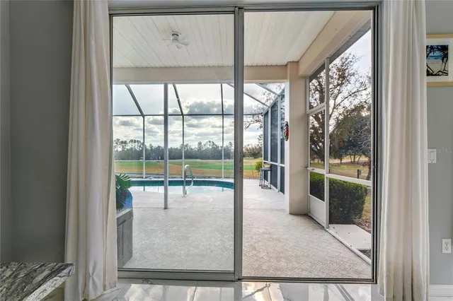 a view of a house with swimming pool and a yard with a large tree