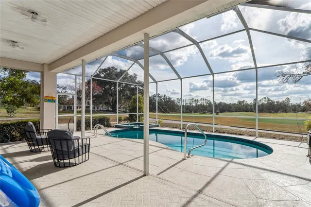 an aerial view of residential houses with outdoor space and swimming pool