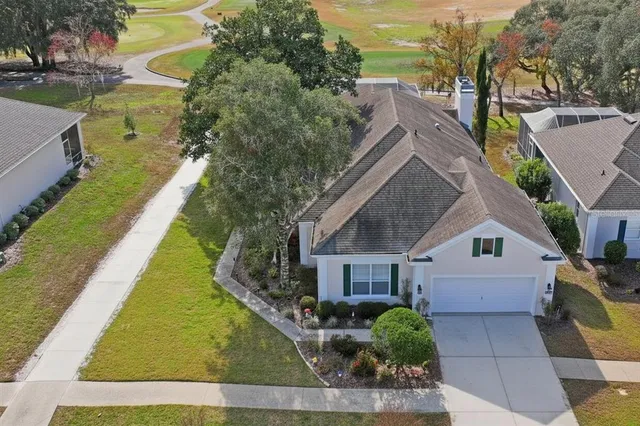 a front view of a house with yard swimming pool and outdoor seating