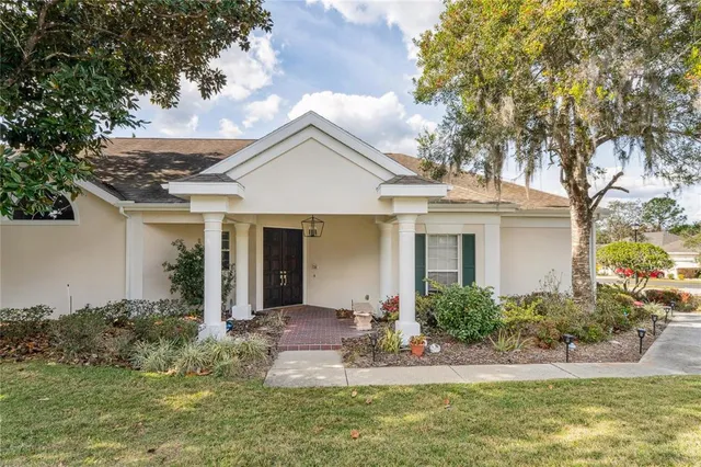 a view of a hallway with wooden floor and a living room