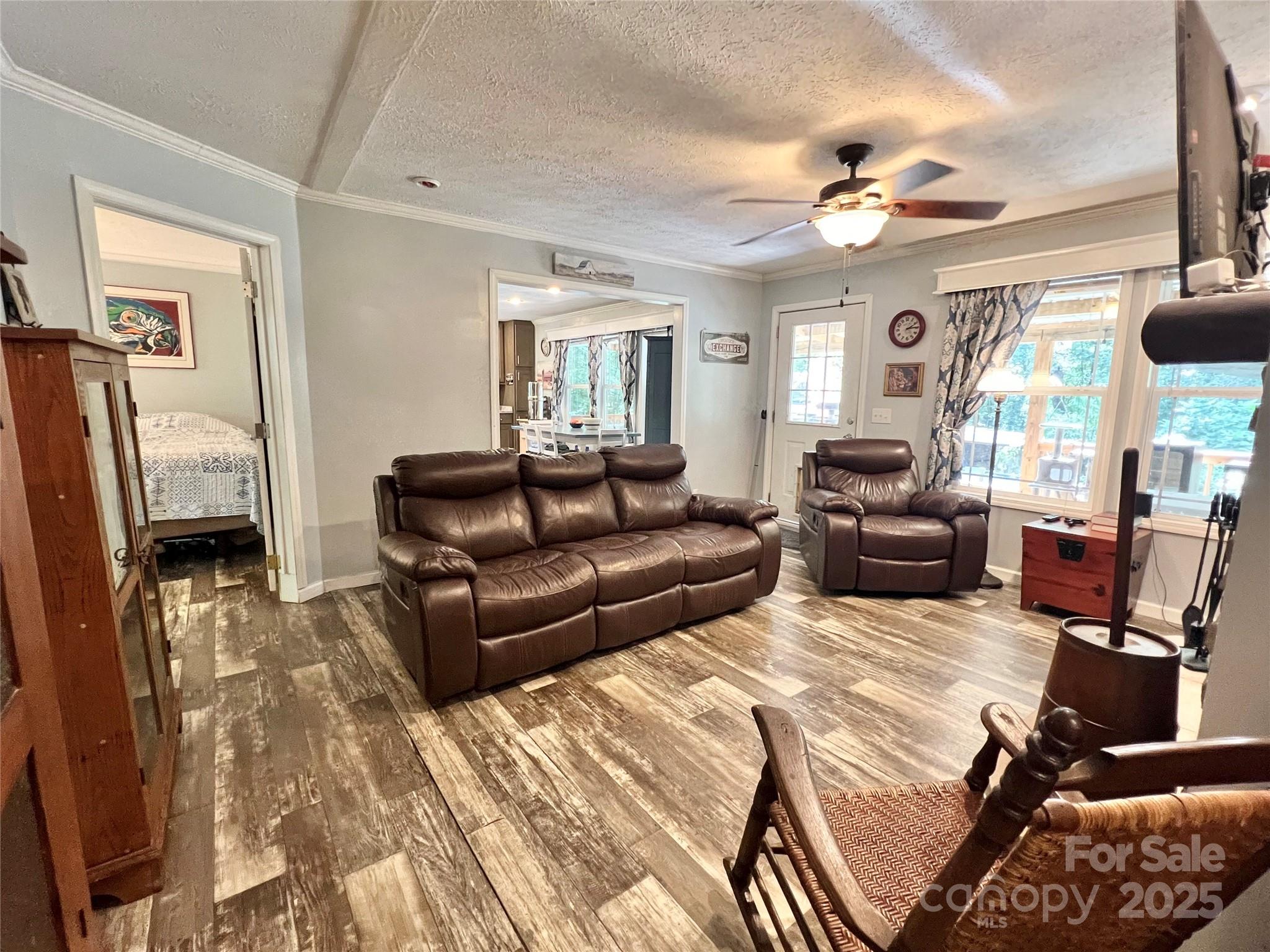 1258 Willis Road Chester, SC 29706 - Photo 11 of 32 a living room with furniture a chandelier and a flat screen tv