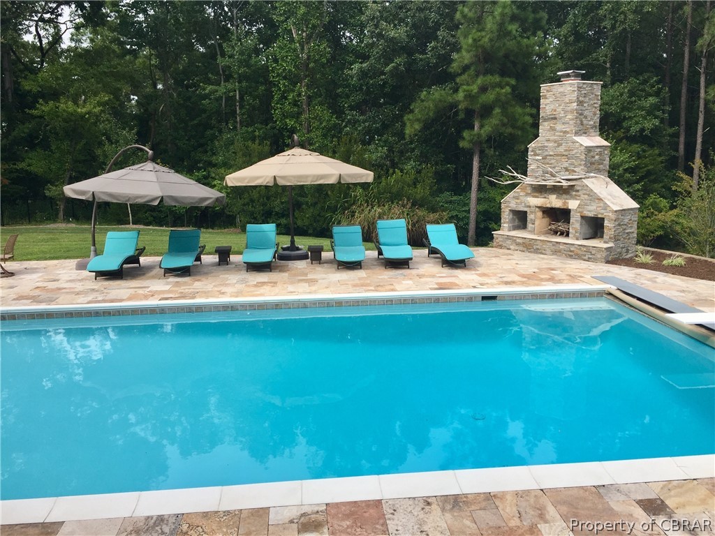 1000 Queenstown Road Lancaster, VA 22503 - Photo 15 of 49 a backyard of a house with table and chairs