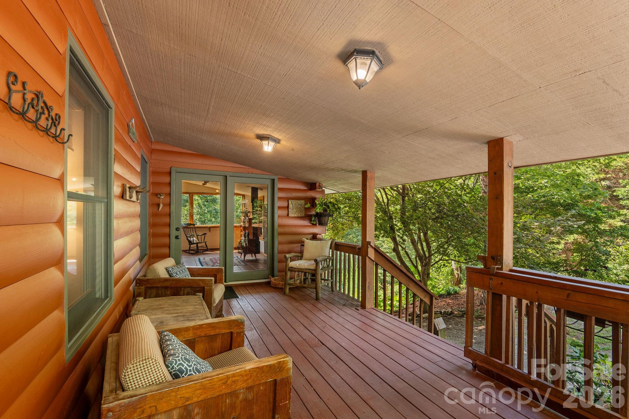 150 Avondale Ridge Road Asheville, NC 28803 - Photo 5 of 45 a view of a balcony with couch and wooden floor