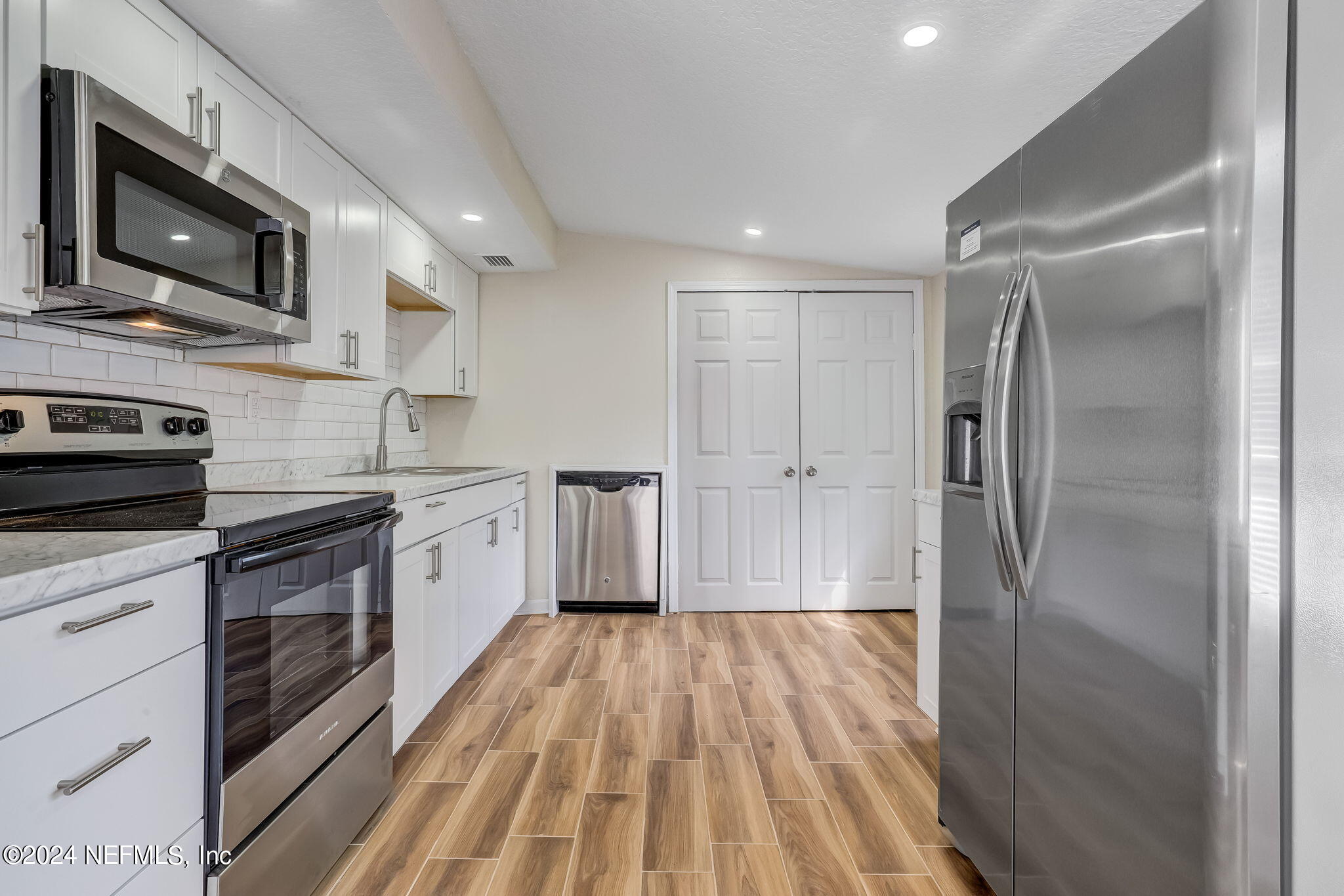 4917 Dundee Road Jacksonville, FL 32210 - Photo 1 of 26 a kitchen with stainless steel appliances granite countertop a refrigerator a stove top oven a sink and dishwasher