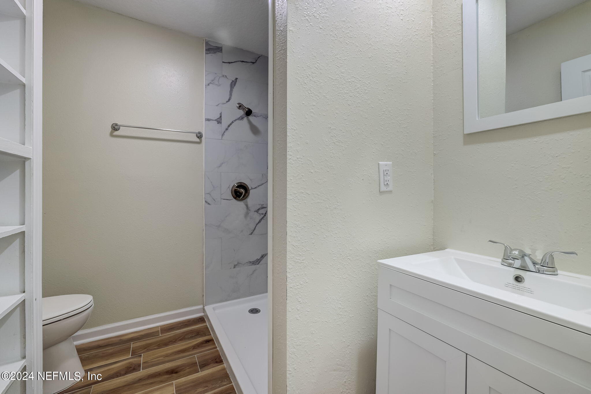 4917 Dundee Road Jacksonville, FL 32210 - Photo 11 of 26 a bathroom with a sink toilet and shower