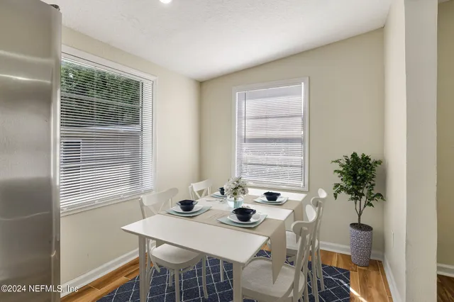 a view of a dining room with furniture and window