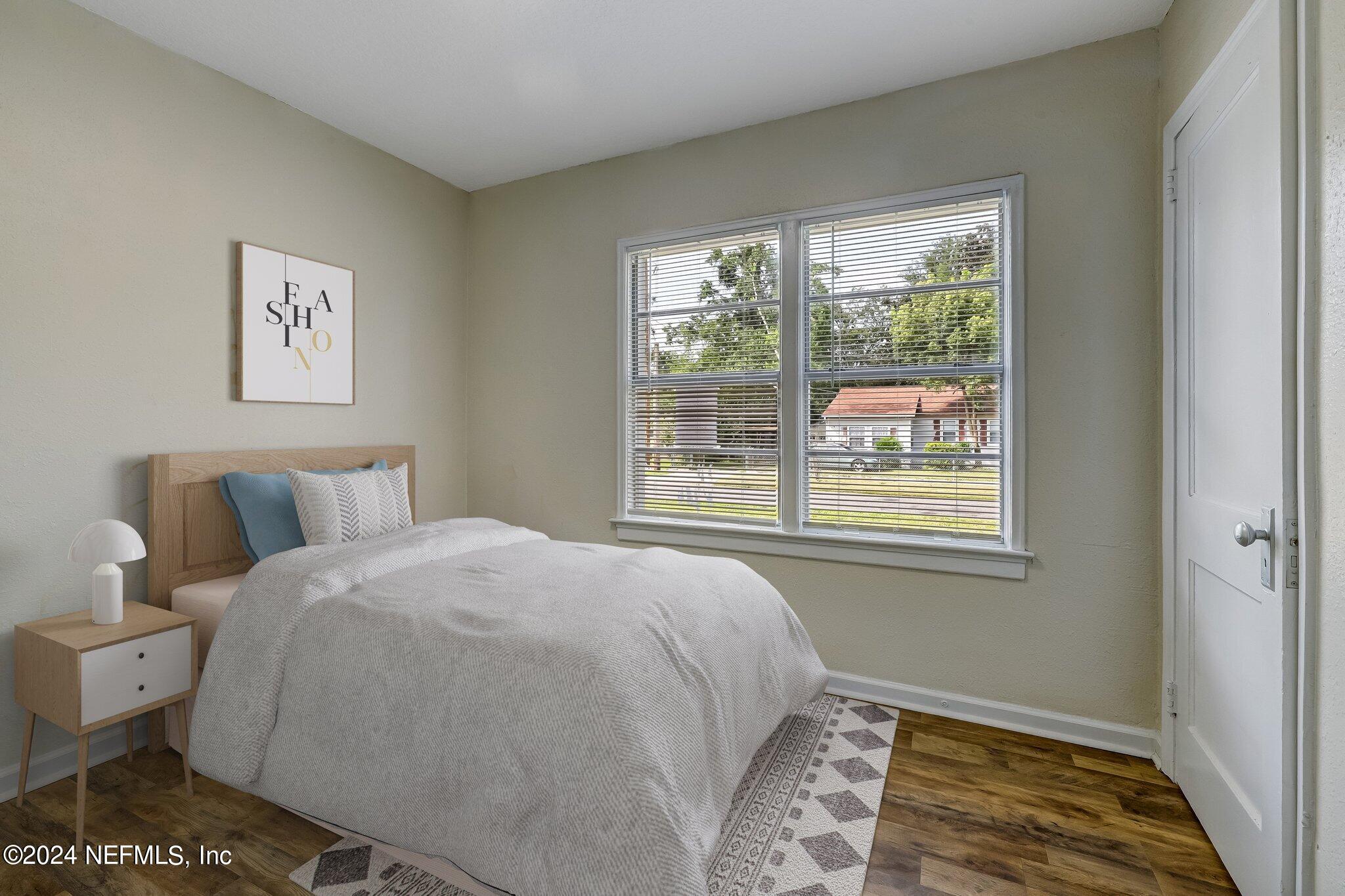 4917 Dundee Road Jacksonville, FL 32210 - Photo 13 of 26 a bedroom with a bed and a window