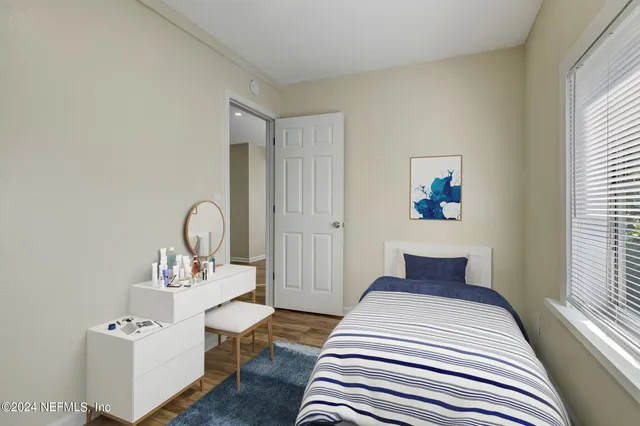 a bedroom with a bed and a table with window