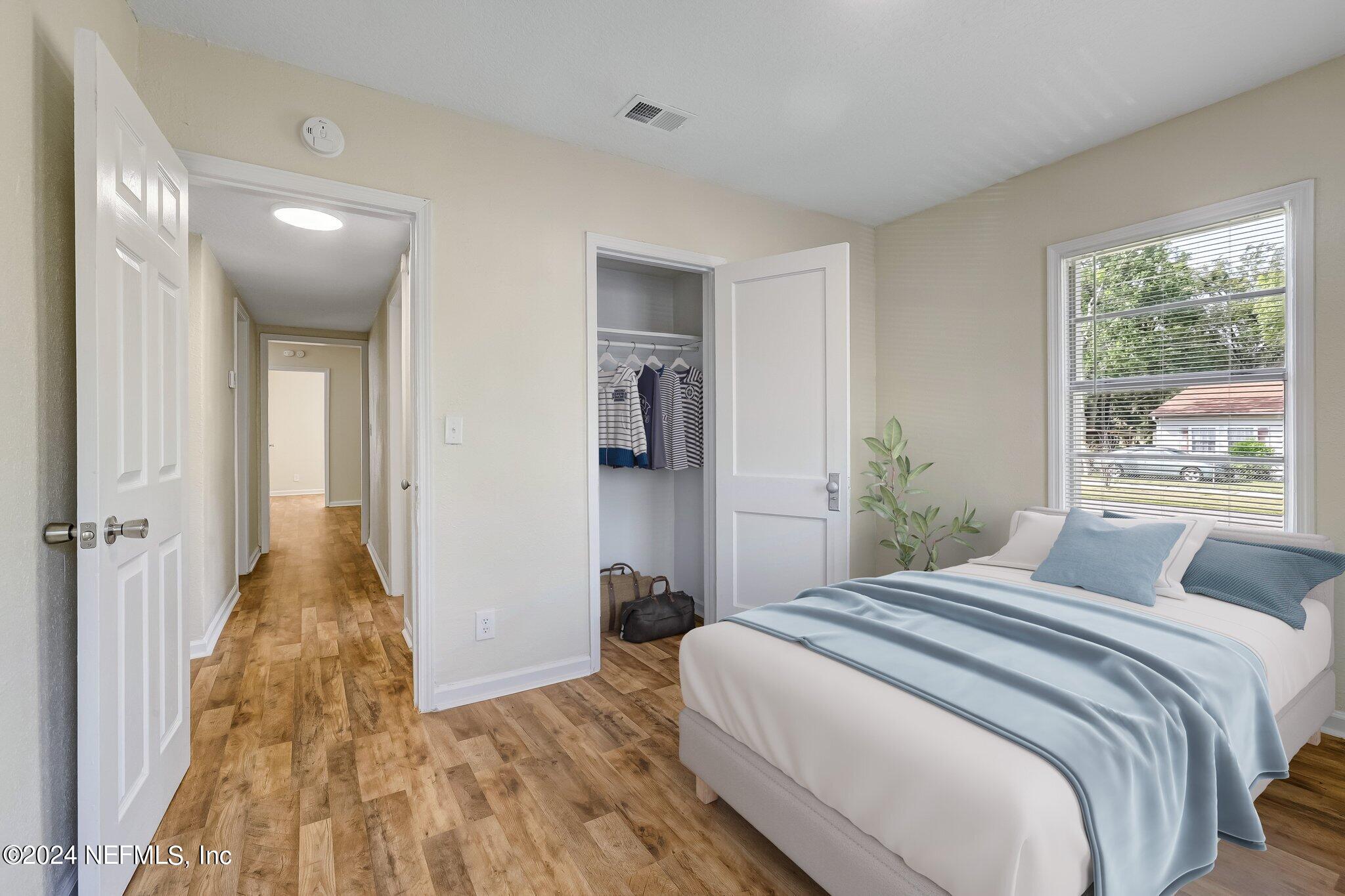 4917 Dundee Road Jacksonville, FL 32210 - Photo 18 of 26 a bedroom with a bed and a large window