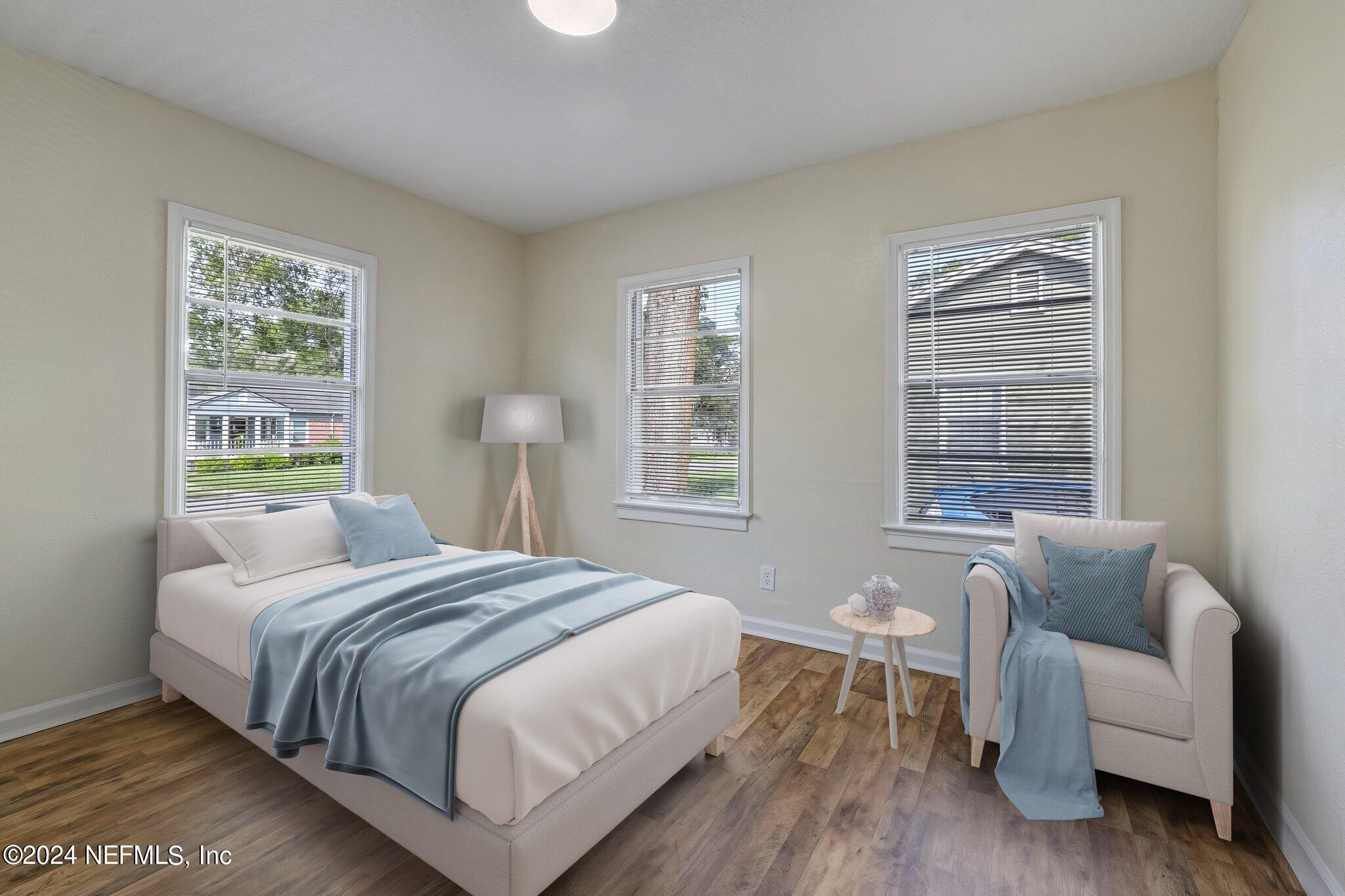 4917 Dundee Road Jacksonville, FL 32210 - Photo 19 of 26 a bedroom with a bed and a couch