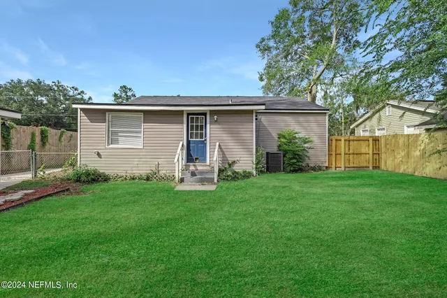 a front view of house with yard and green space