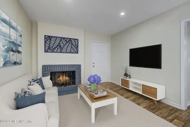 a living room with furniture and a fireplace