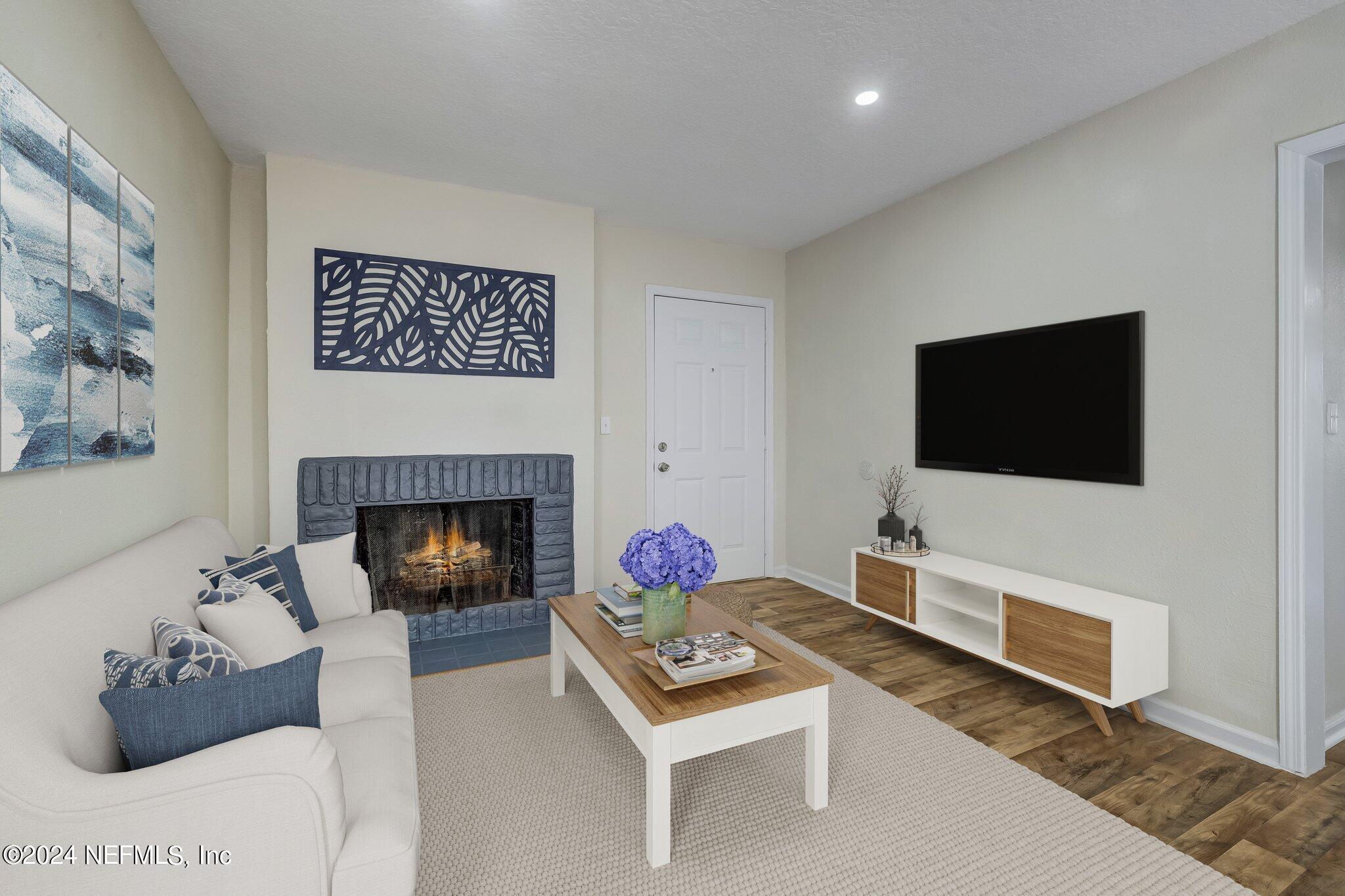 4917 Dundee Road Jacksonville, FL 32210 - Photo 3 of 26 a living room with furniture and a fireplace