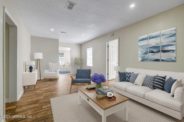 a living room with furniture and wooden floor