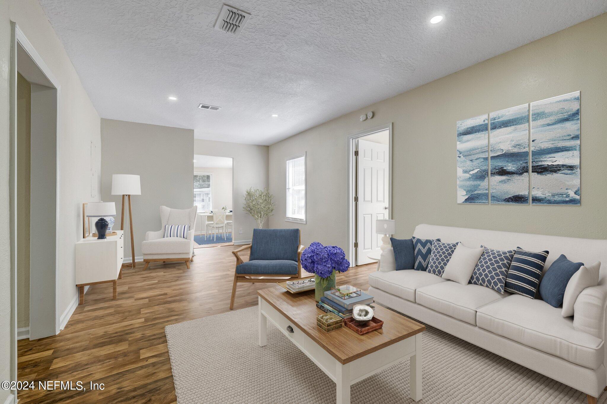 4917 Dundee Road Jacksonville, FL 32210 - Photo 4 of 26 a living room with furniture and wooden floor