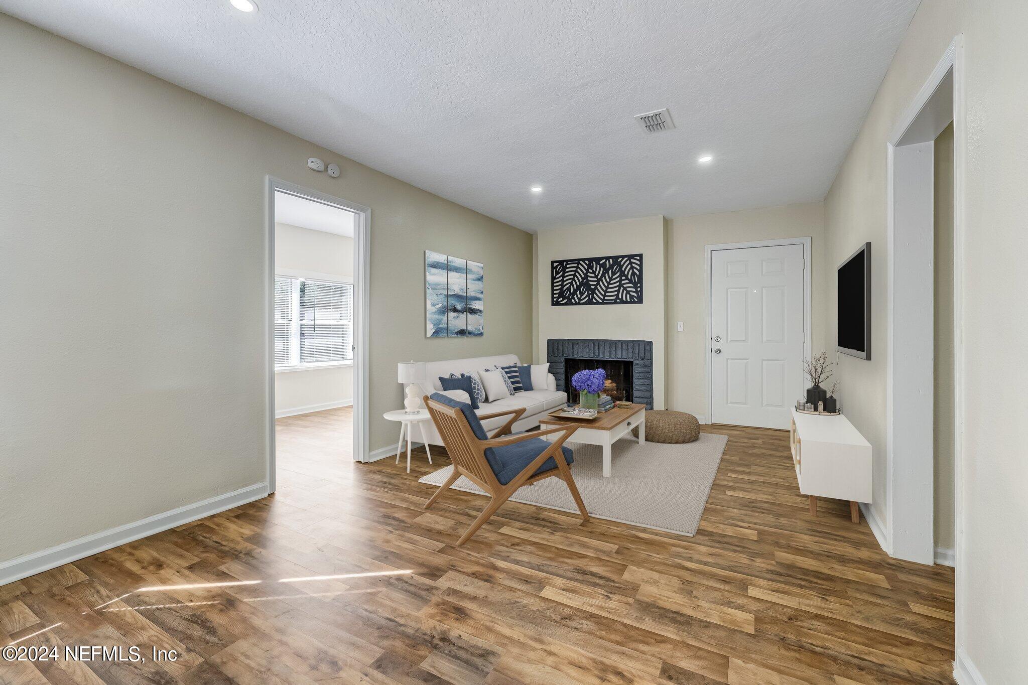 4917 Dundee Road Jacksonville, FL 32210 - Photo 5 of 26 a living room with furniture and a fireplace