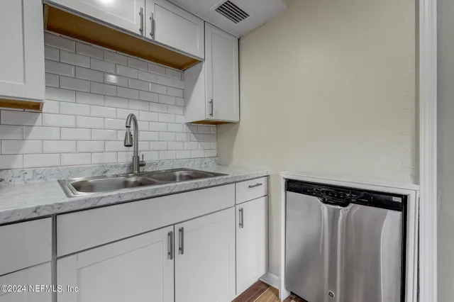 a kitchen with a sink and cabinets