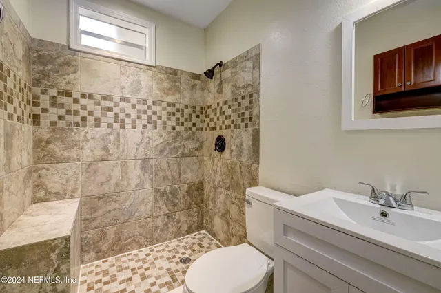 a bathroom with a sink toilet and shower