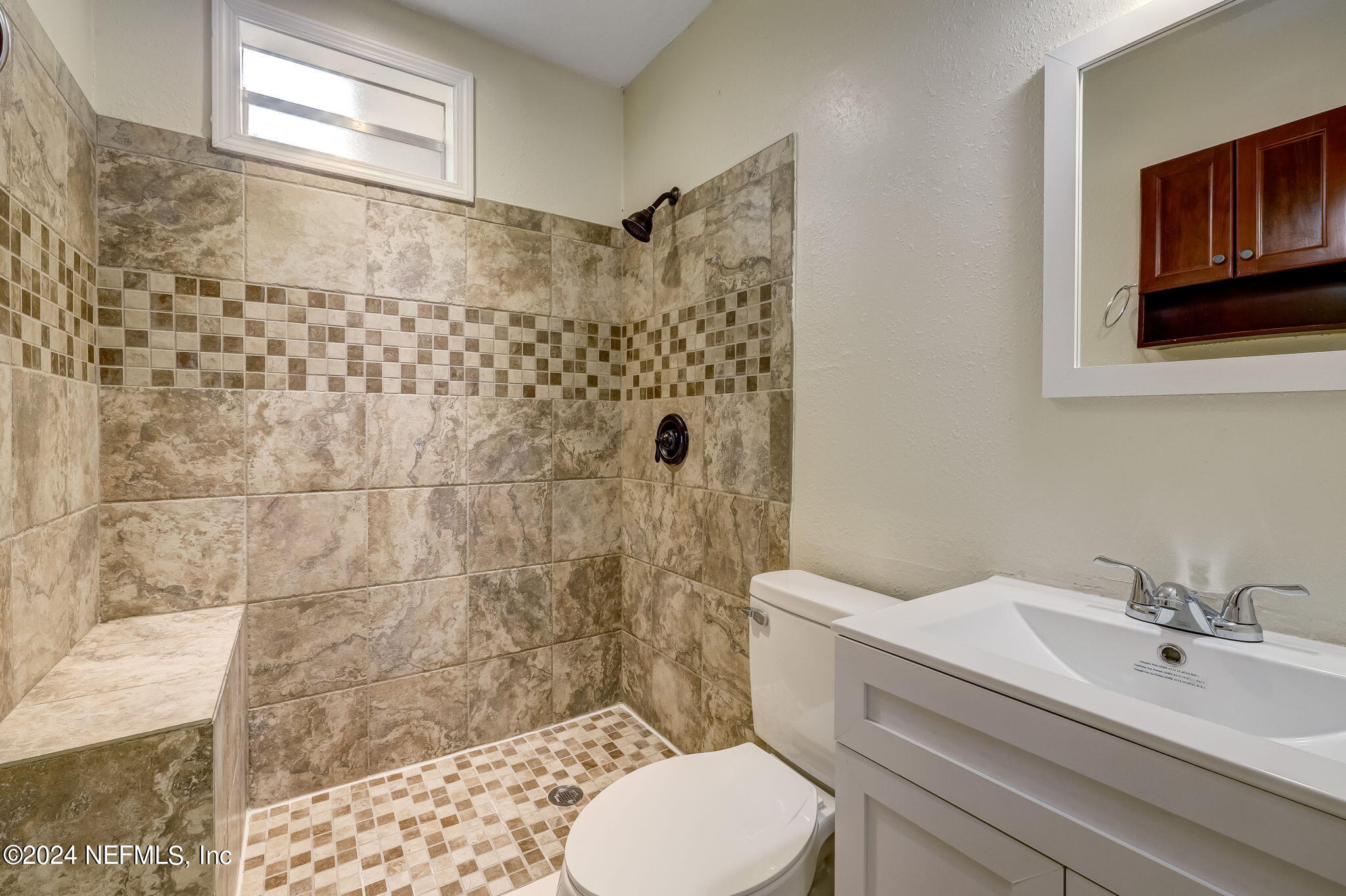4917 Dundee Road Jacksonville, FL 32210 - Photo 10 of 26 a bathroom with a sink toilet and shower