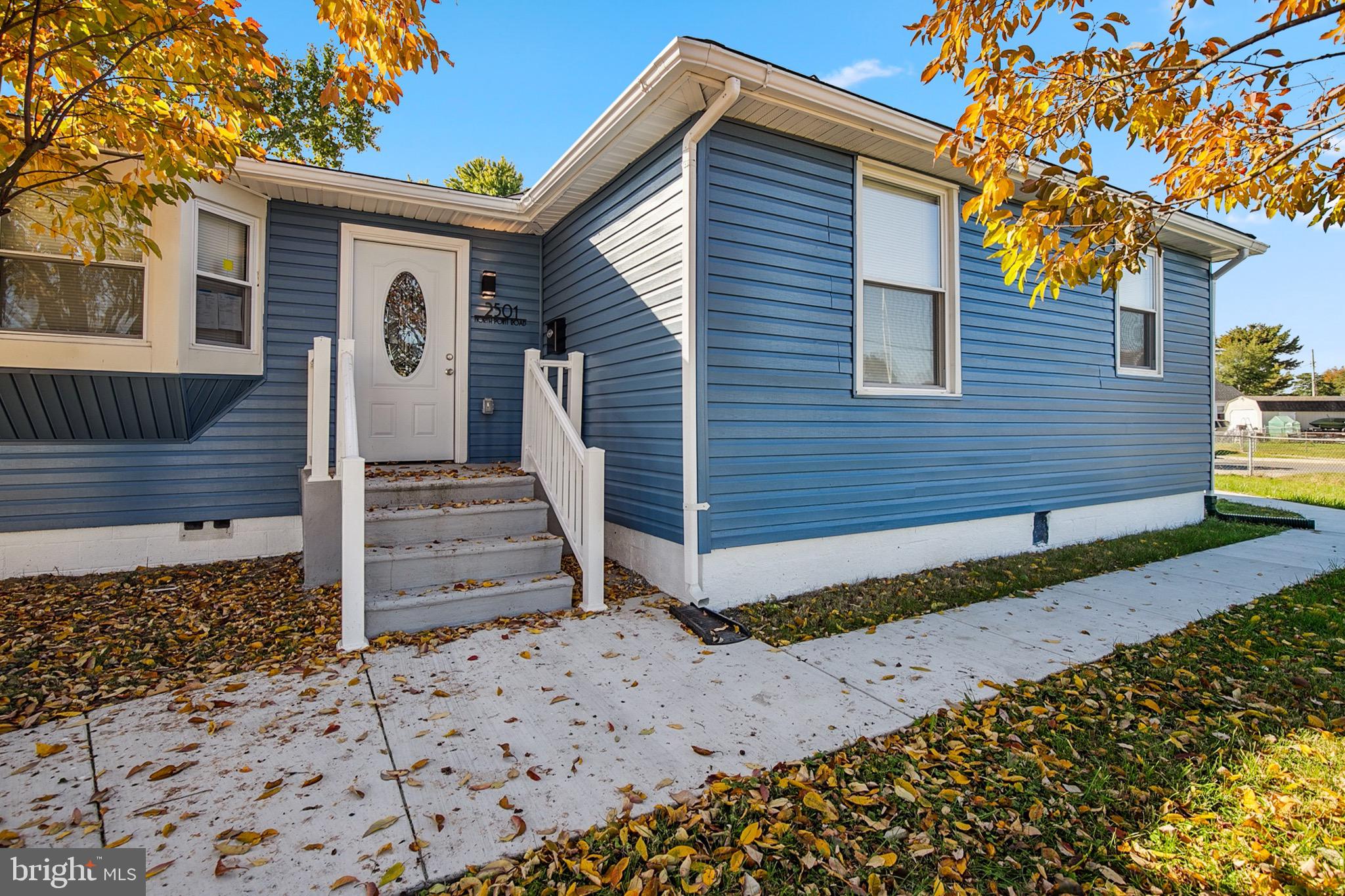 a view of a house with wooden fence