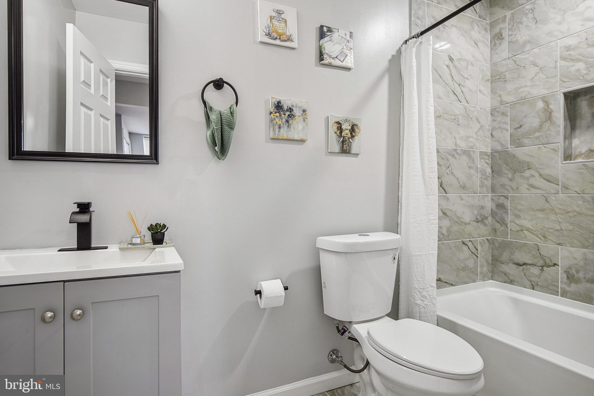 2501 North Point Road Dundalk, MD 21222 - Photo 11 of 28 a white toilet sitting next to a bathroom sink