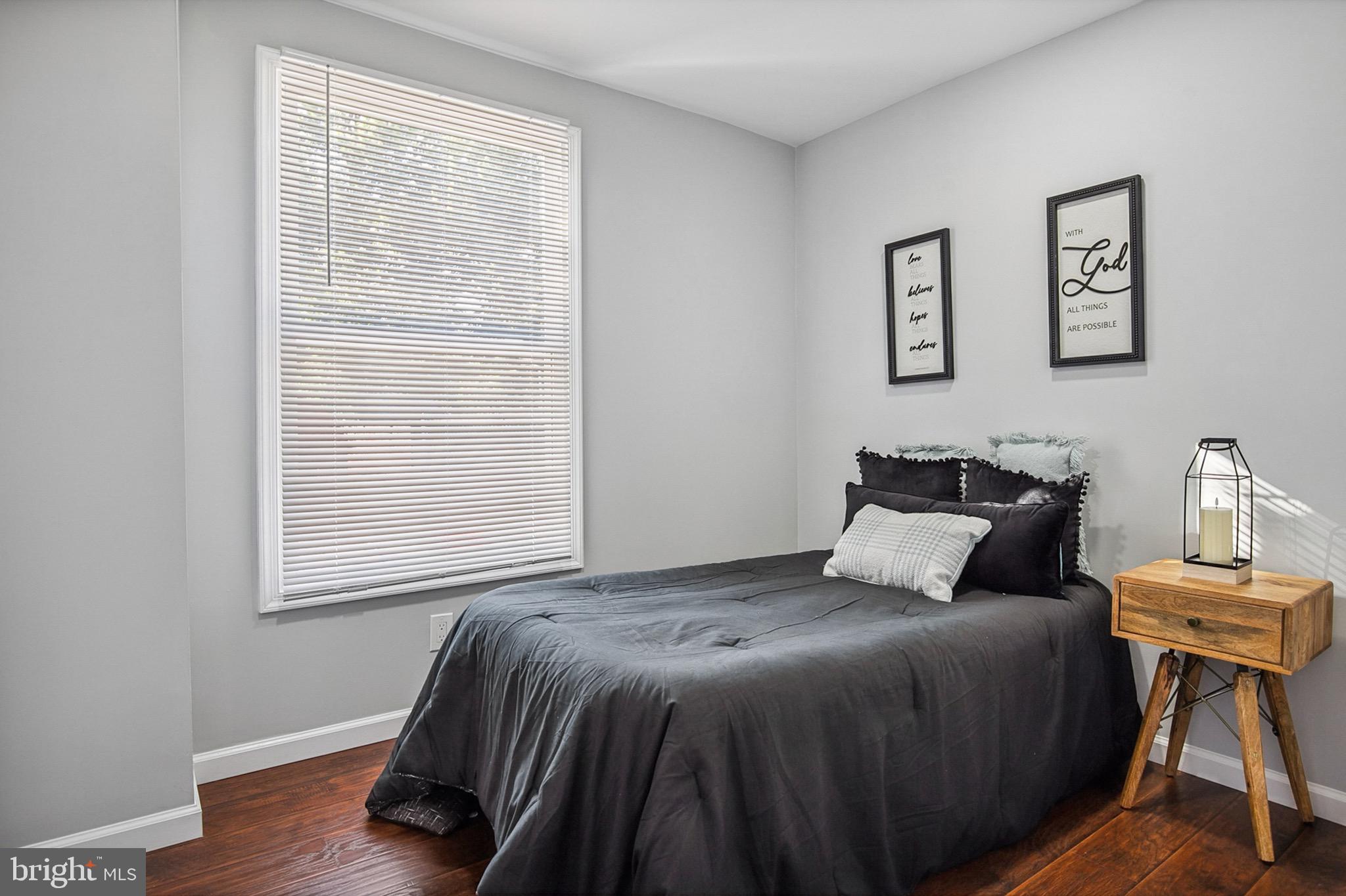 2501 North Point Road Dundalk, MD 21222 - Photo 12 of 28 a bedroom with a bed and wooden floor
