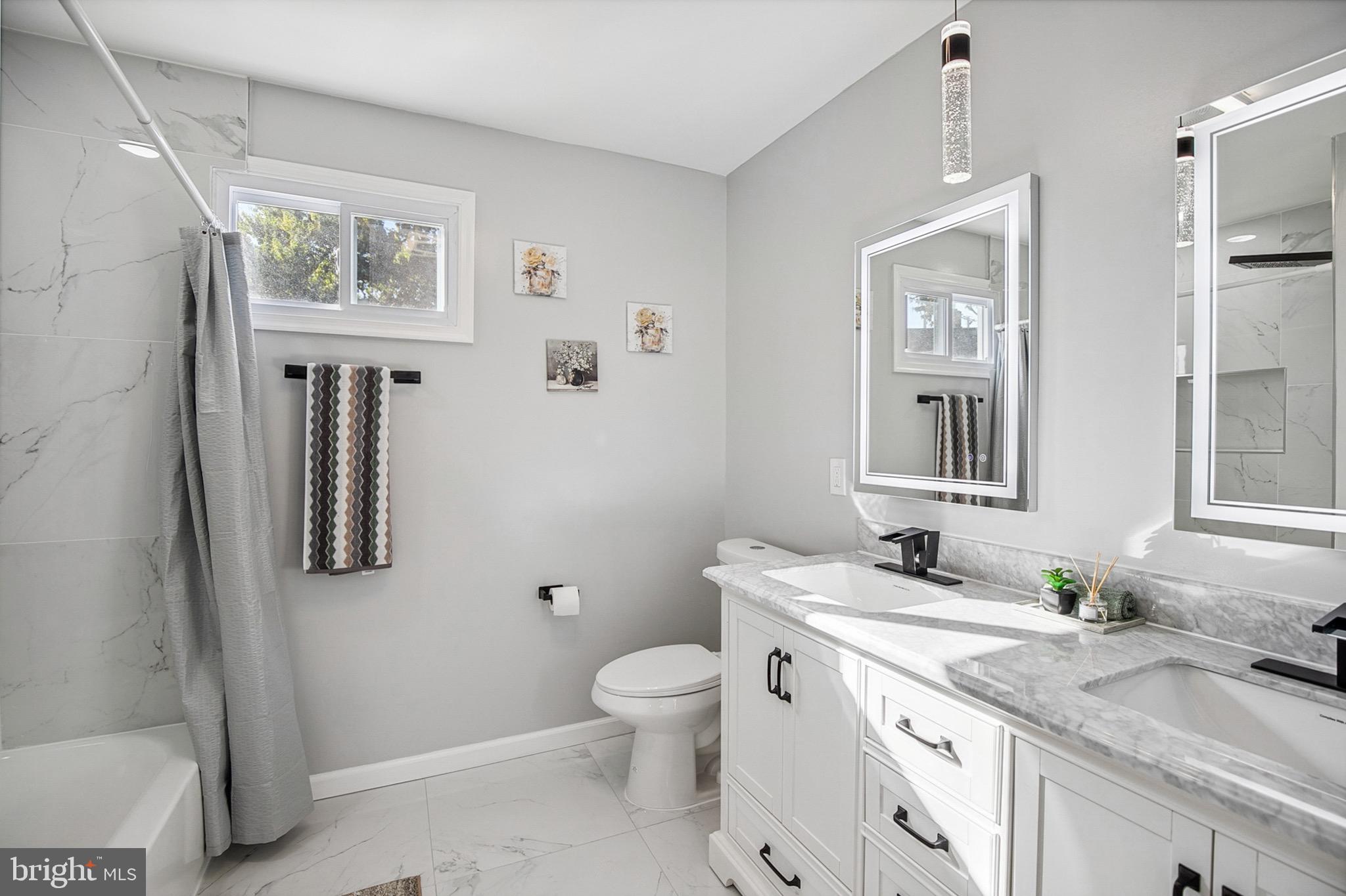 2501 North Point Road Dundalk, MD 21222 - Photo 19 of 28 a bathroom with a granite countertop sink toilet and mirror