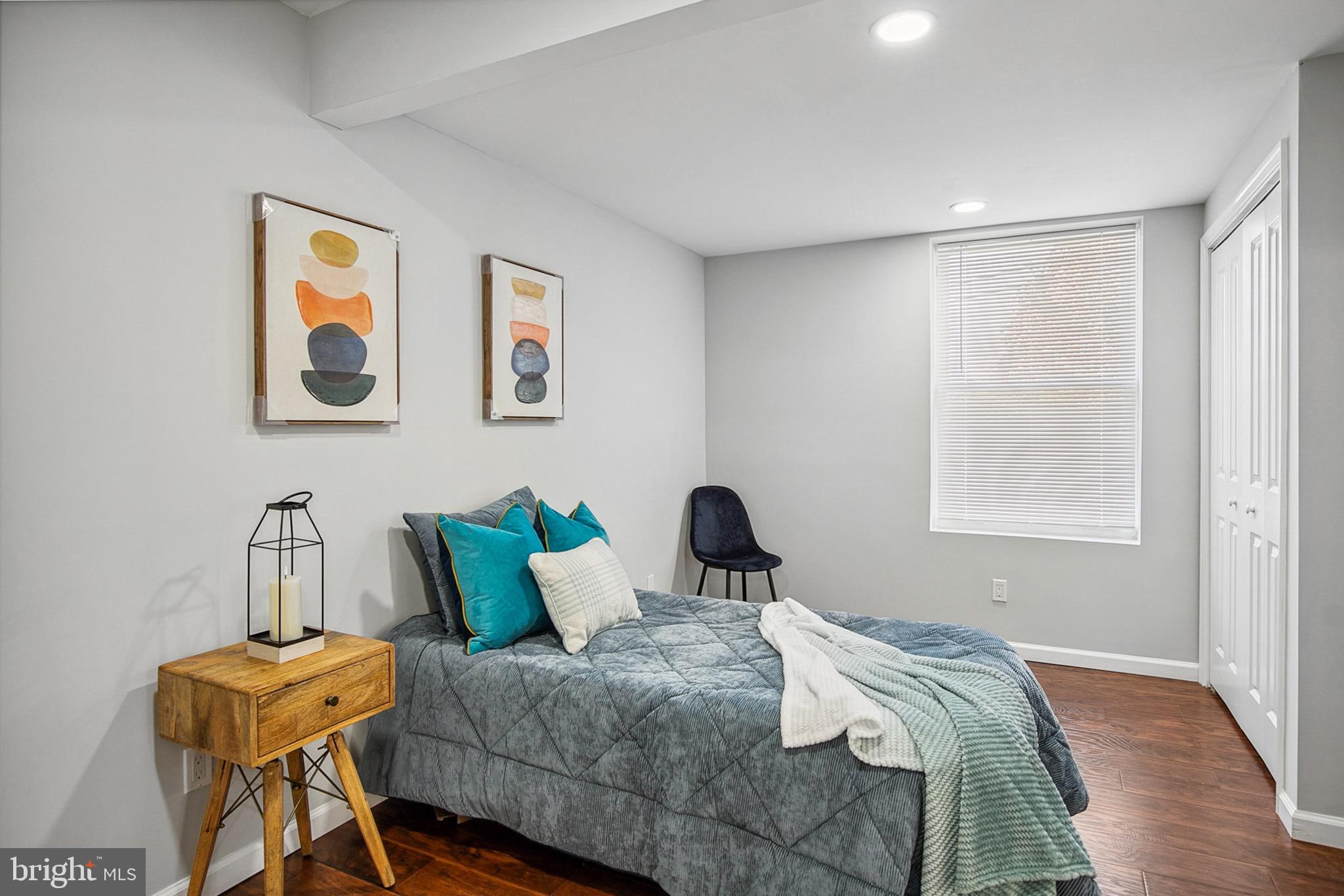 2501 North Point Road Dundalk, MD 21222 - Photo 10 of 28 a bedroom with a bed and wooden floor