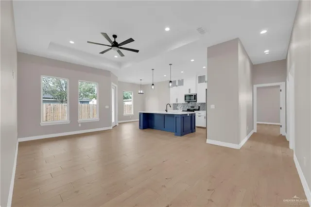 a view of kitchen and kitchen with a refrigerator