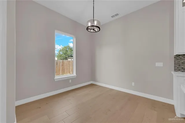 an empty room with windows and entrance