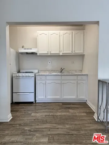 a kitchen with white cabinets