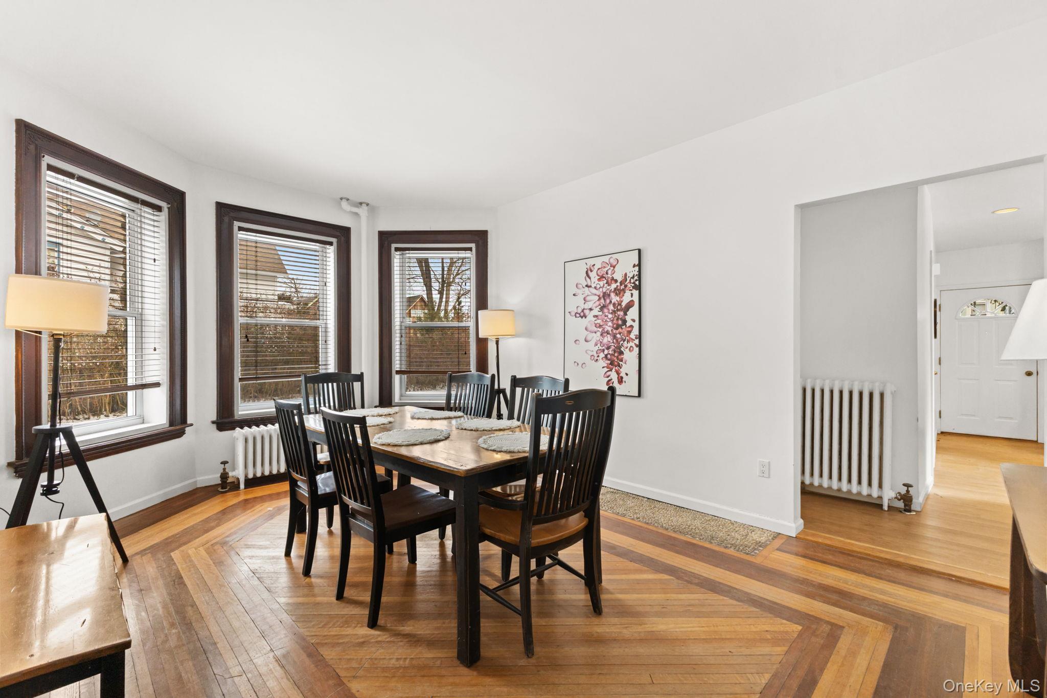 16 Bedford Road, Unit 1 Katonah, NY 10536 - Photo 6 of 10 a view of a a dining room with furniture window and wooden floor