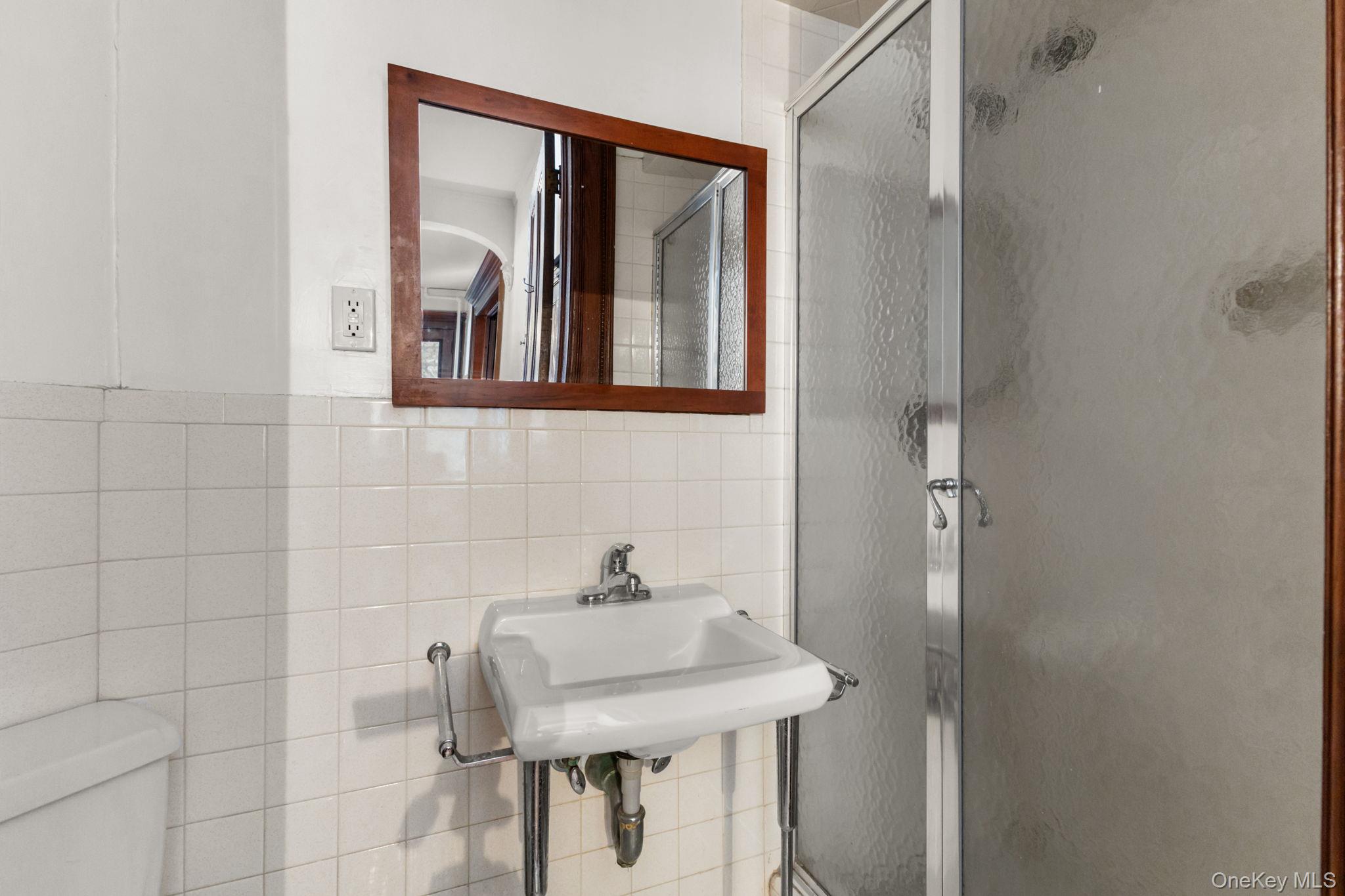 16 Bedford Road, Unit 1 Katonah, NY 10536 - Photo 8 of 10 a bathroom with a sink and a mirror