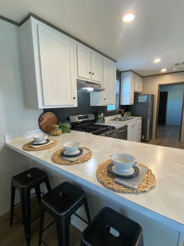 a kitchen with a dining table and chairs