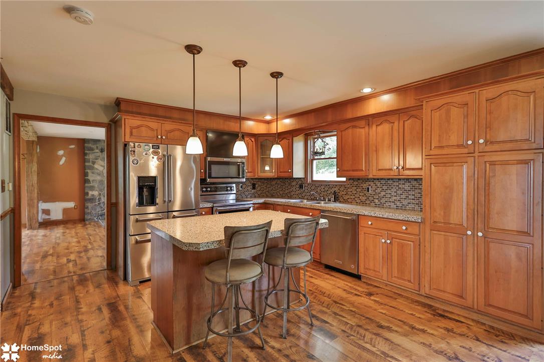 829 Georgetown Road Nazareth, PA 18064 - Photo 19 of 54 Rich wood cabinetry paired with stone countertops defines this warm, inviting kitchen space.