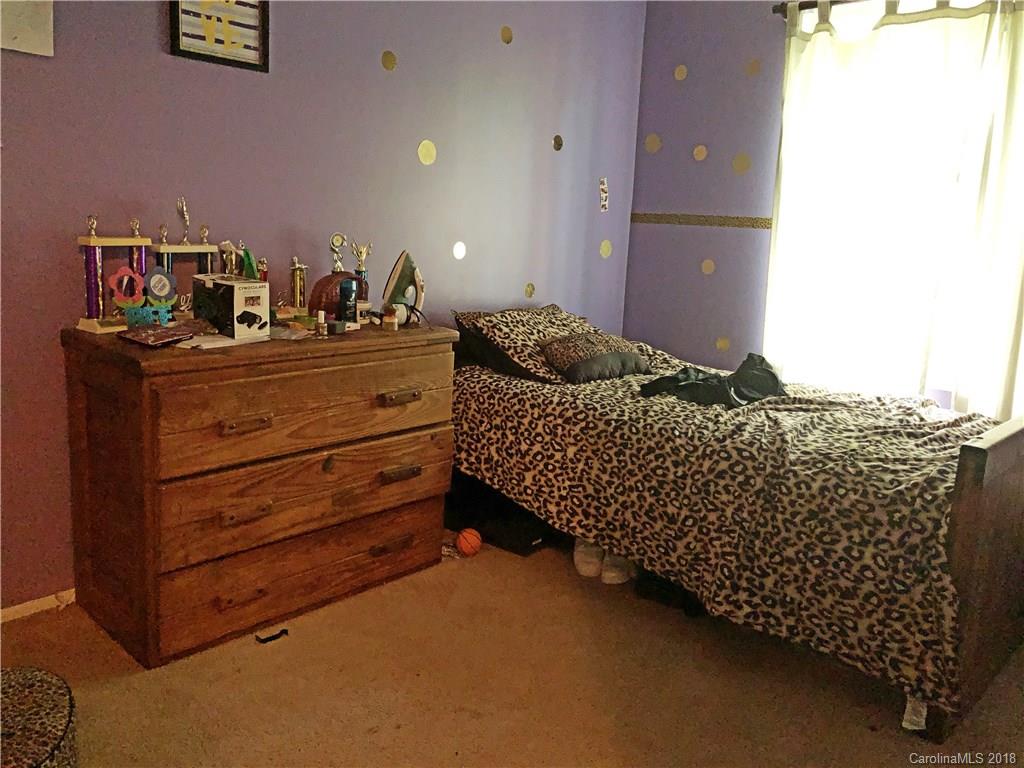 6637 Saddle Point Road Charlotte, NC 28212 - Photo 5 of 7 a bed room with a bed and a night stand