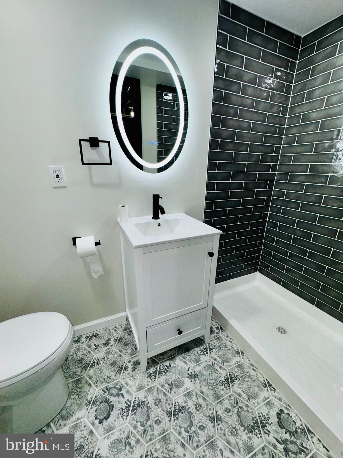 1912 Barry Road Dundalk, MD 21222 - Photo 18 of 23 a bathroom with a sink a toilet and a mirror
