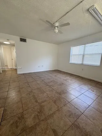 a view of a livingroom with an empty space and window