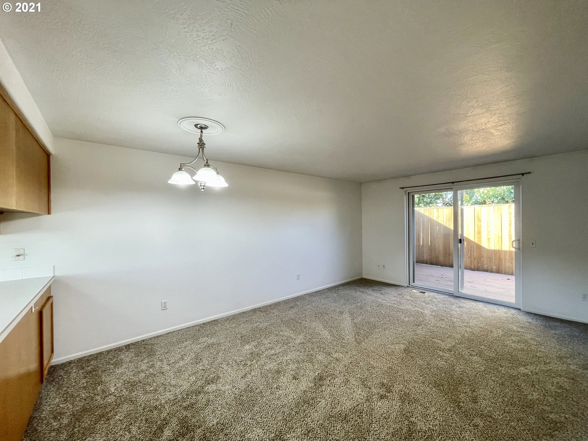 994 West L Street Springfield, OR 97477 - Photo 5 of 26 an empty room with a fireplace and windows